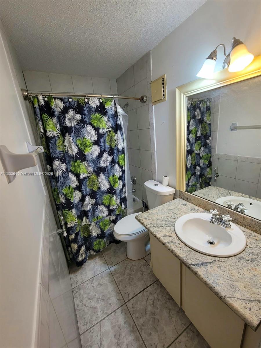 11 Olive Drive, Unit J Hialeah, FL 33010 - Photo 10 of 20 a bathroom with a sink toilet and shower