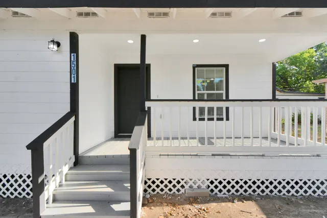 a view of balcony with wooden floor and fence