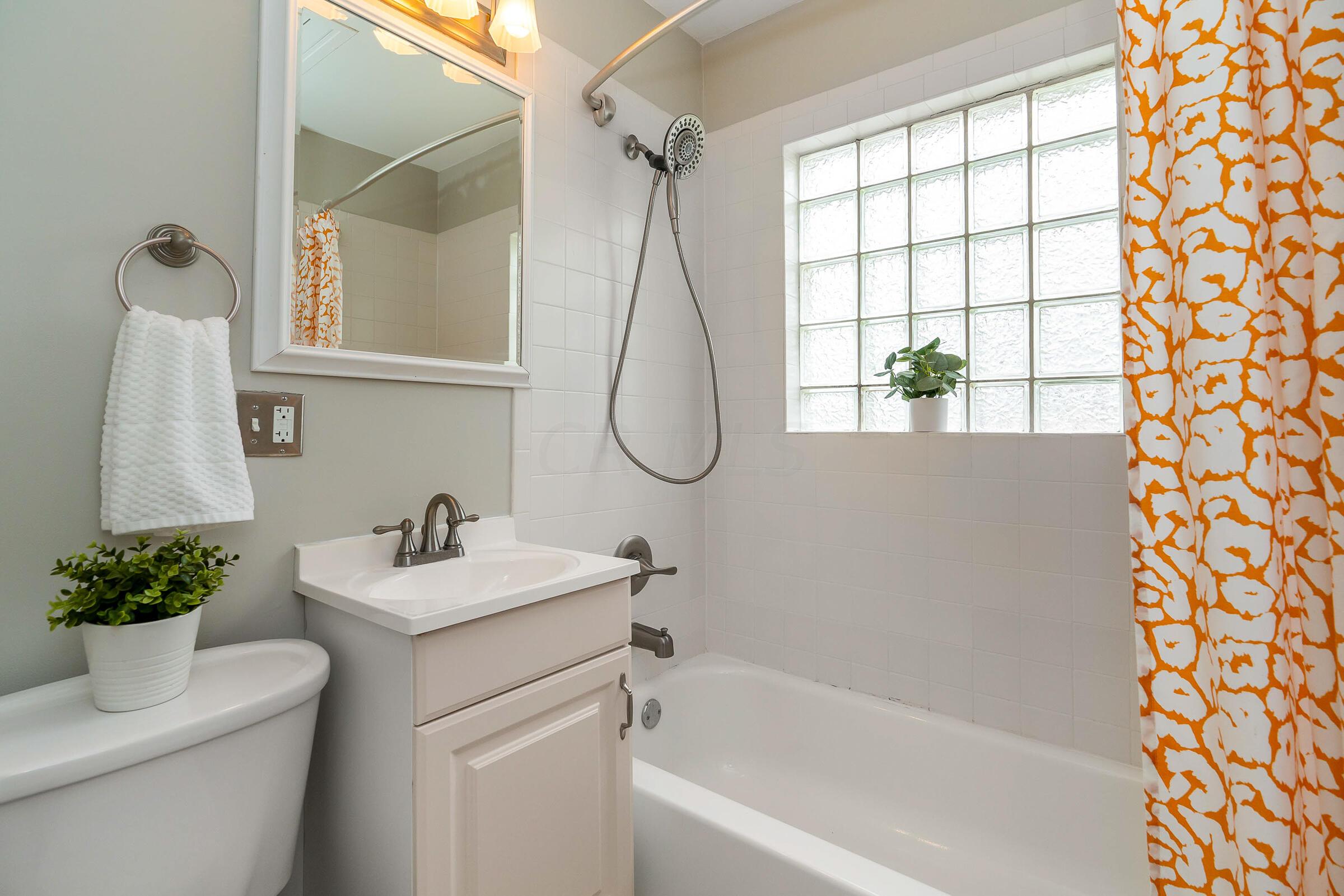 588 Northridge Road Columbus, OH 43214 - Photo 19 of 31 Updated full bathroom features glass block & tile surround in the tub/shower.