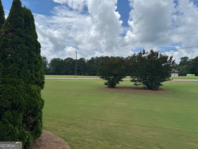 a view of a workspace with furniture and wooden floor