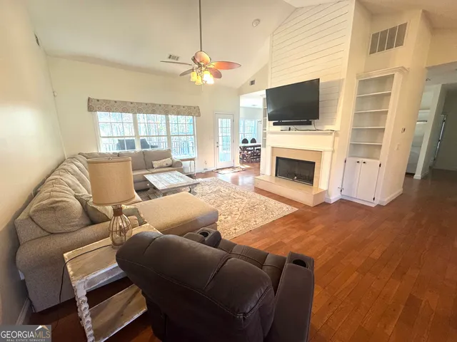 a living room with a flat screen tv and a fireplace