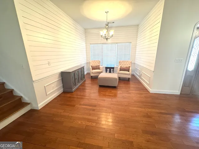 a large kitchen with cabinets wooden floor and stainless steel appliances
