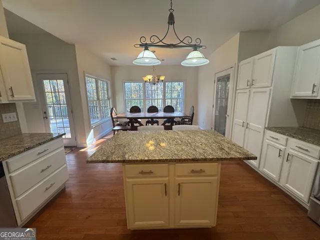 a view of a dining room with furniture wooden floor and chandelier