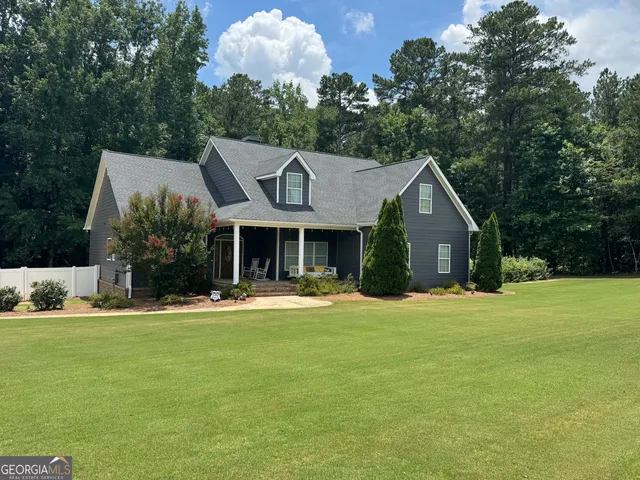 a front view of house with yard and green space