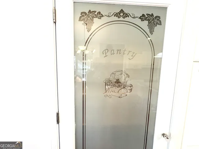 a view of a dining room with furniture and a chandelier