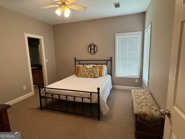 a bathroom with a sink a toilet a mirror and shower