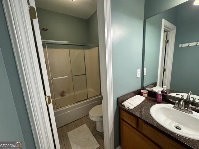 a bathroom with a granite countertop sink a mirror and a vanity