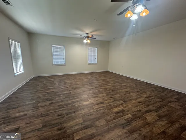 a bathroom with a toilet sink vanity and mirror
