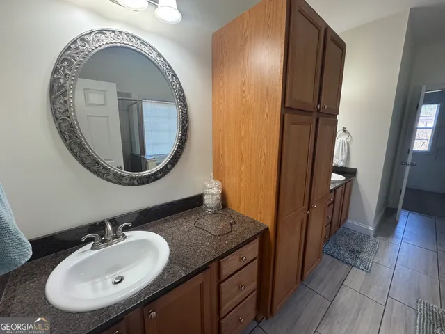 a bathroom with a tub sink and a mirror