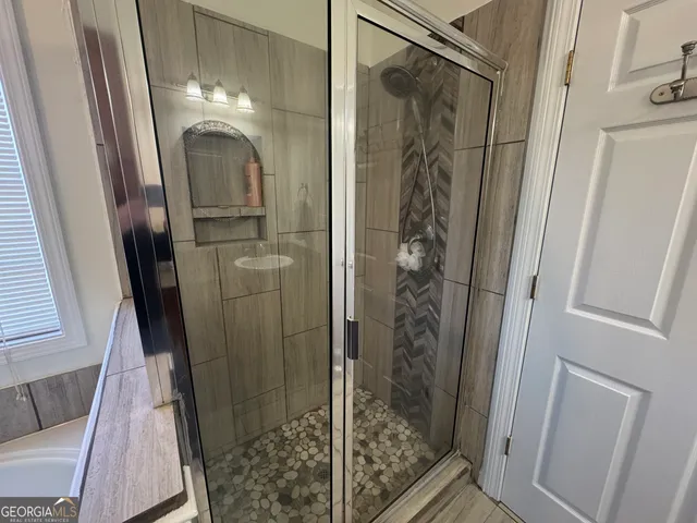 a bath tub sitting in a bathroom next to a window