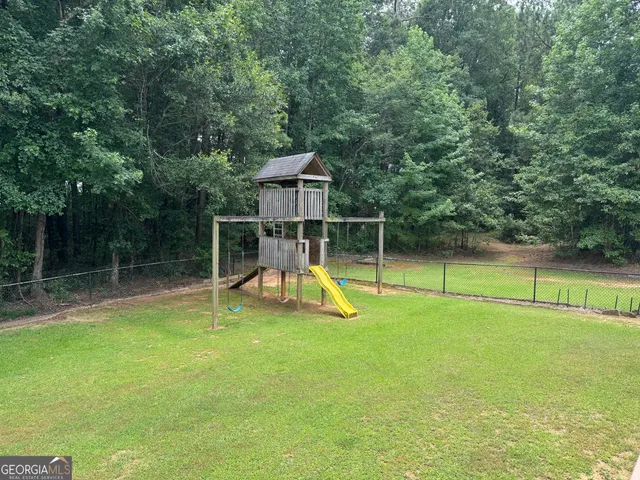 a view of a house with wooden floor and floor to ceiling windows