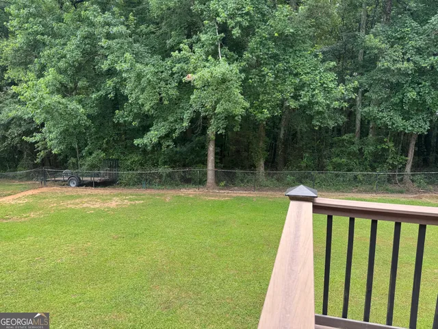 a view of a backyard with large trees