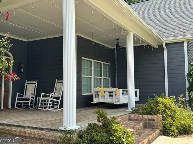a view of a patio with table and chairs and potted plants