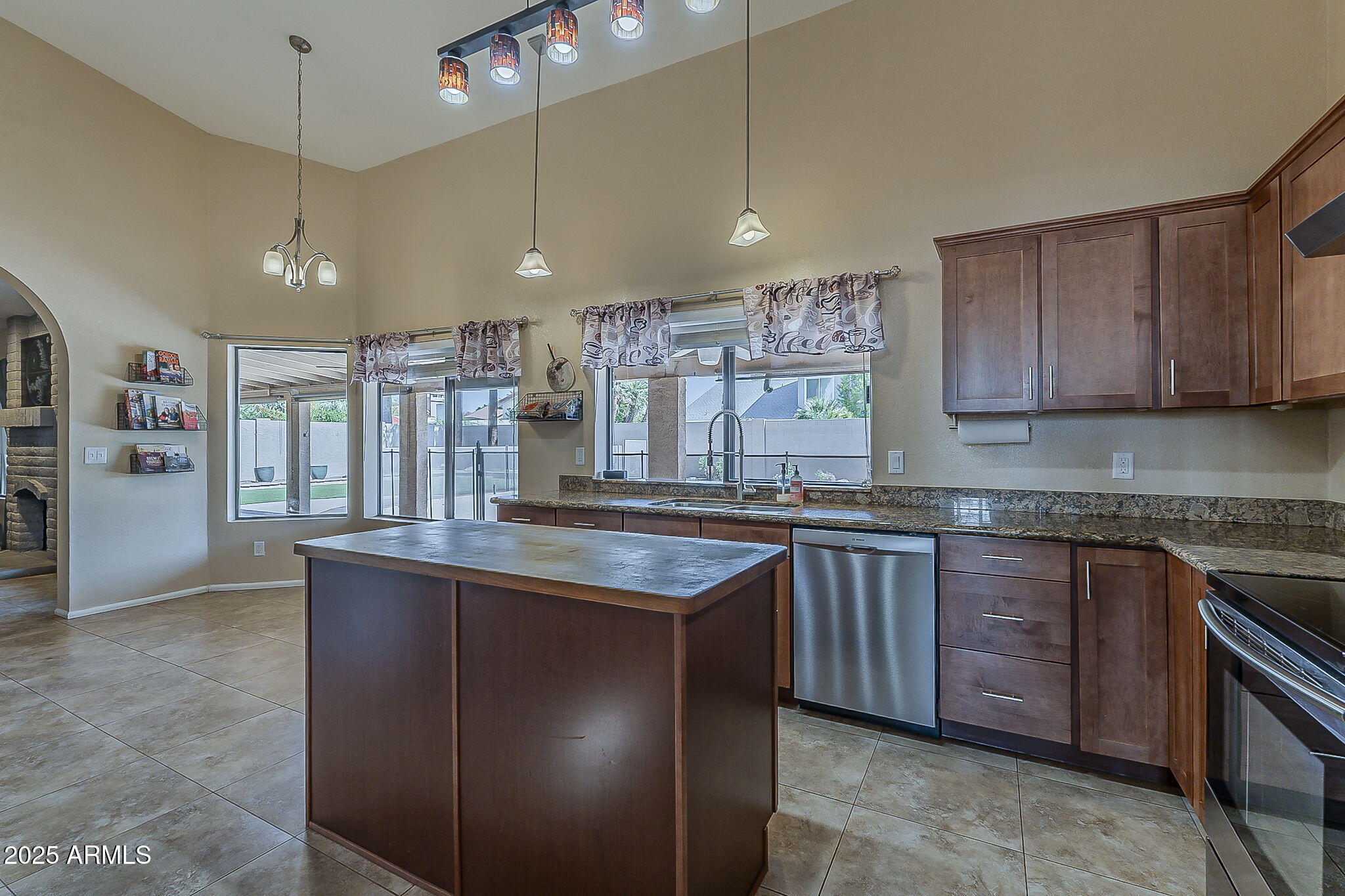 1927 East Ranch Road Tempe, AZ 85284 - Photo 12 of 64 a kitchen with stainless steel appliances granite countertop a sink a stove and a wooden cabinets
