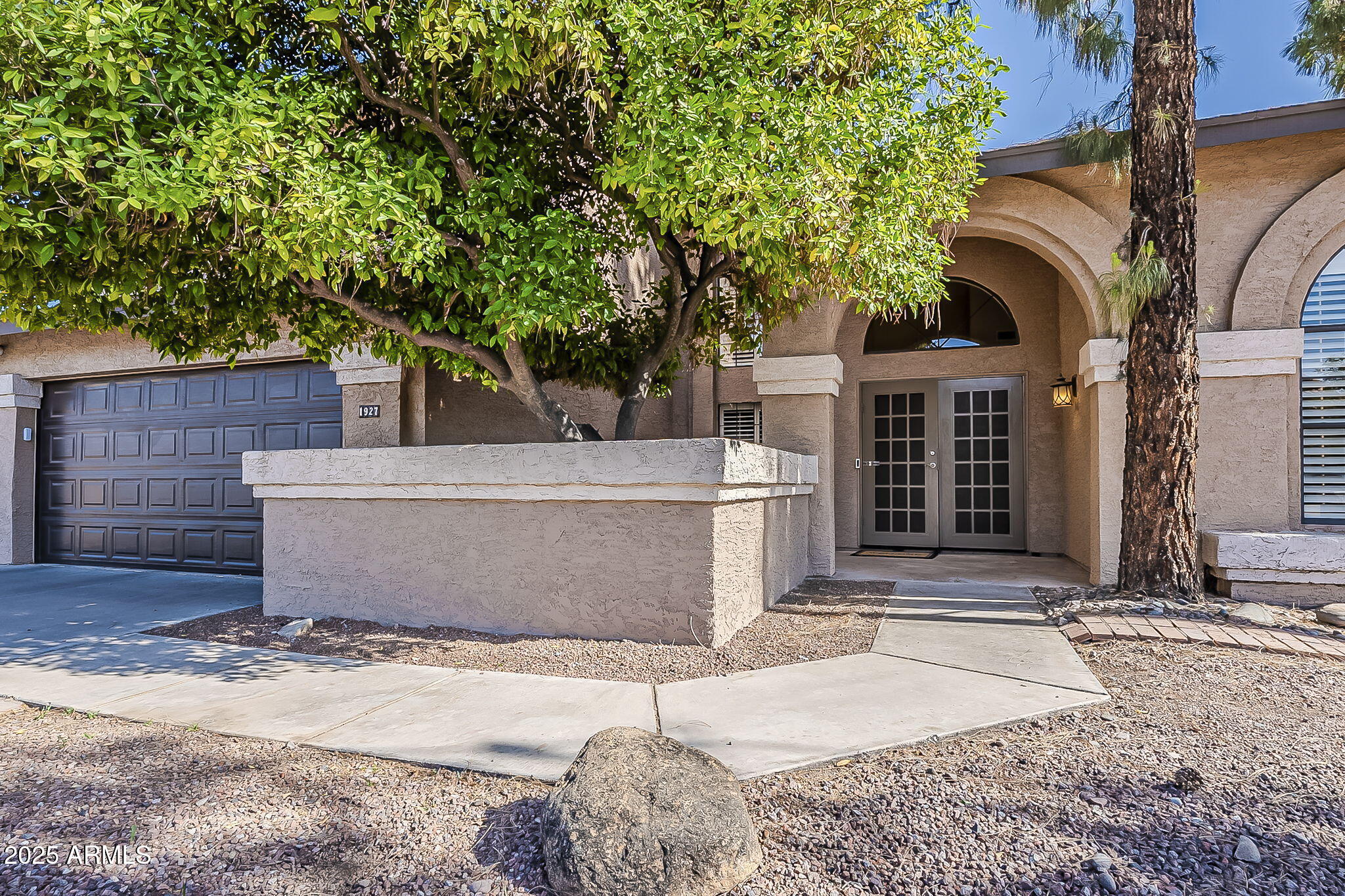 1927 East Ranch Road Tempe, AZ 85284 - Photo 2 of 64 a view of a house with a tree and wooden fence