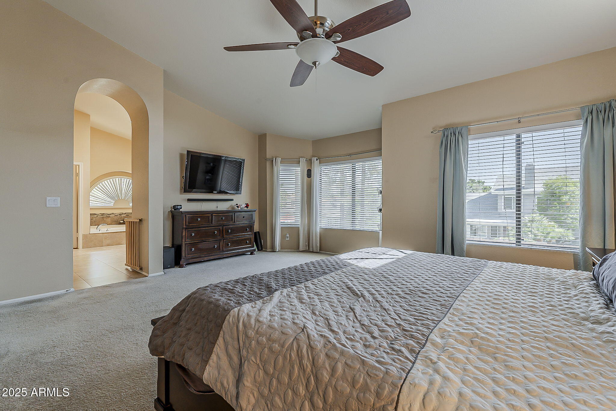 1927 East Ranch Road Tempe, AZ 85284 - Photo 30 of 64 a spacious bedroom with a bed and a flat screen tv
