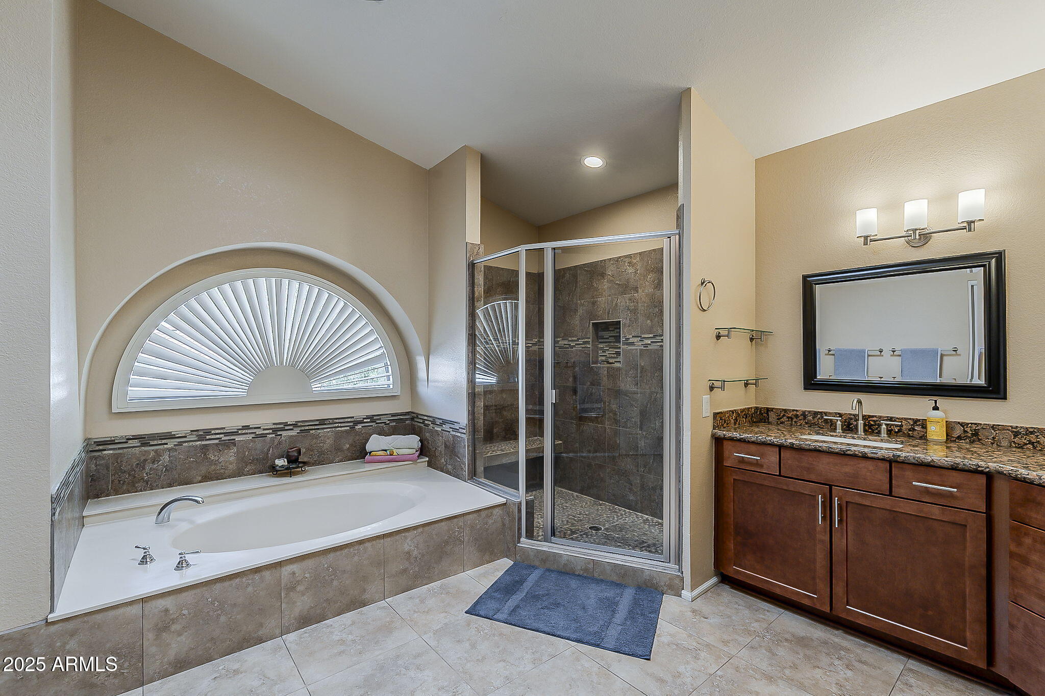 1927 East Ranch Road Tempe, AZ 85284 - Photo 43 of 64 a spacious bathroom with a tub a double vanity sink a mirror and a shower