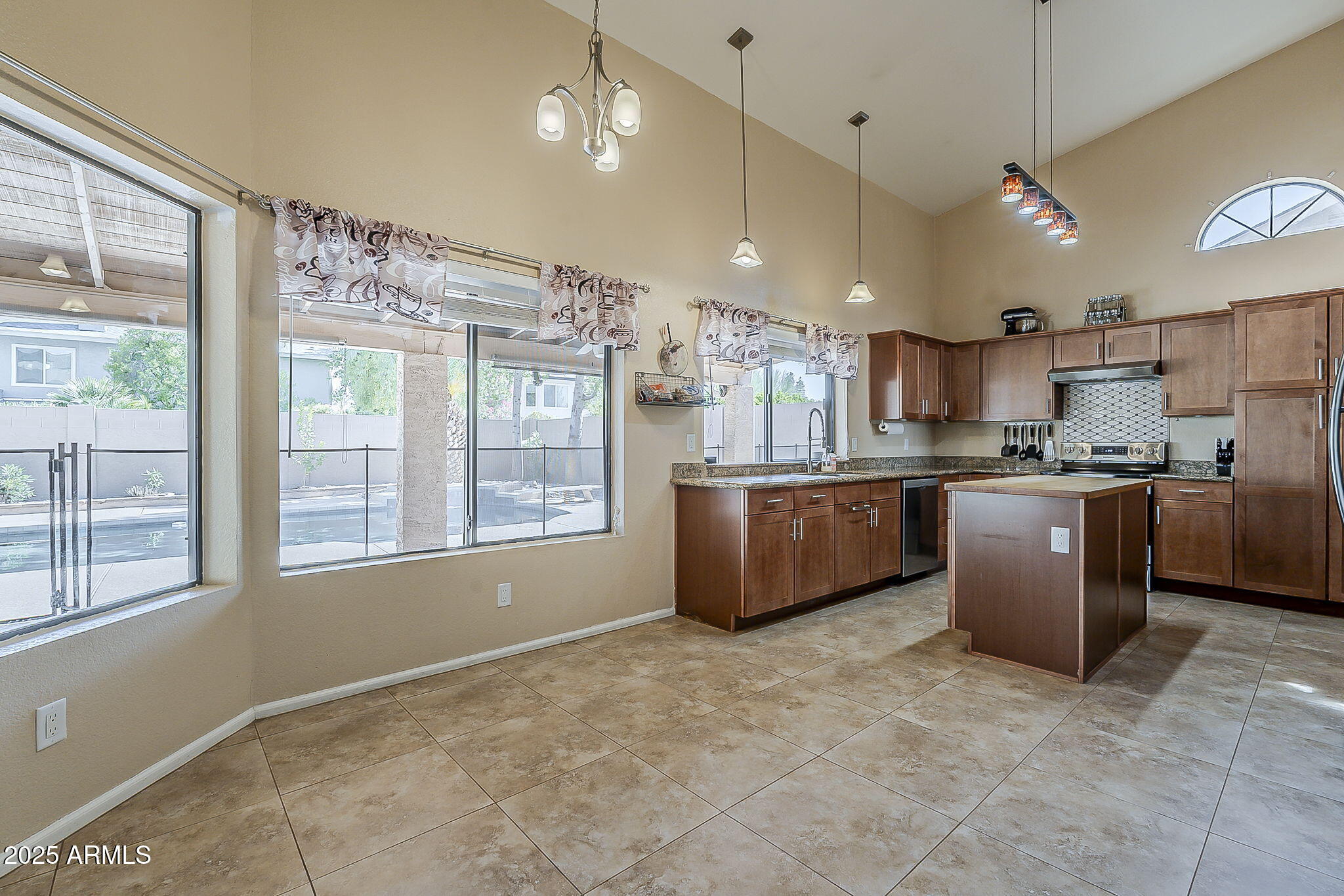1927 East Ranch Road Tempe, AZ 85284 - Photo 8 of 64 a kitchen with stainless steel appliances granite countertop a stove a sink a refrigerator and a cabinets