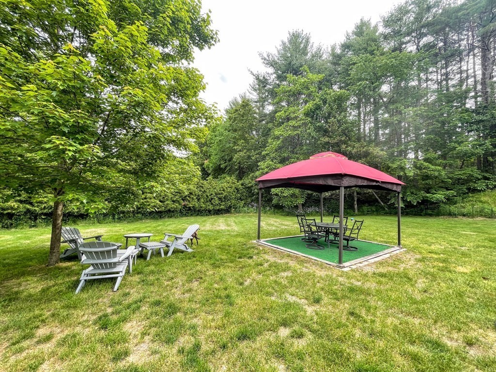 149 Groton Road Shirley, MA 01464 - Photo 24 of 32 a swimming pool with outdoor seating and yard