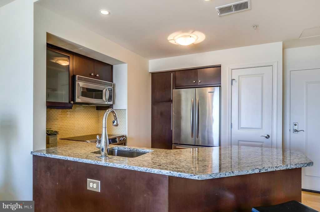 675 President Street, Unit 2607 Baltimore, MD 21202 - Photo 7 of 18 a bathroom with a granite countertop sink and a mirror