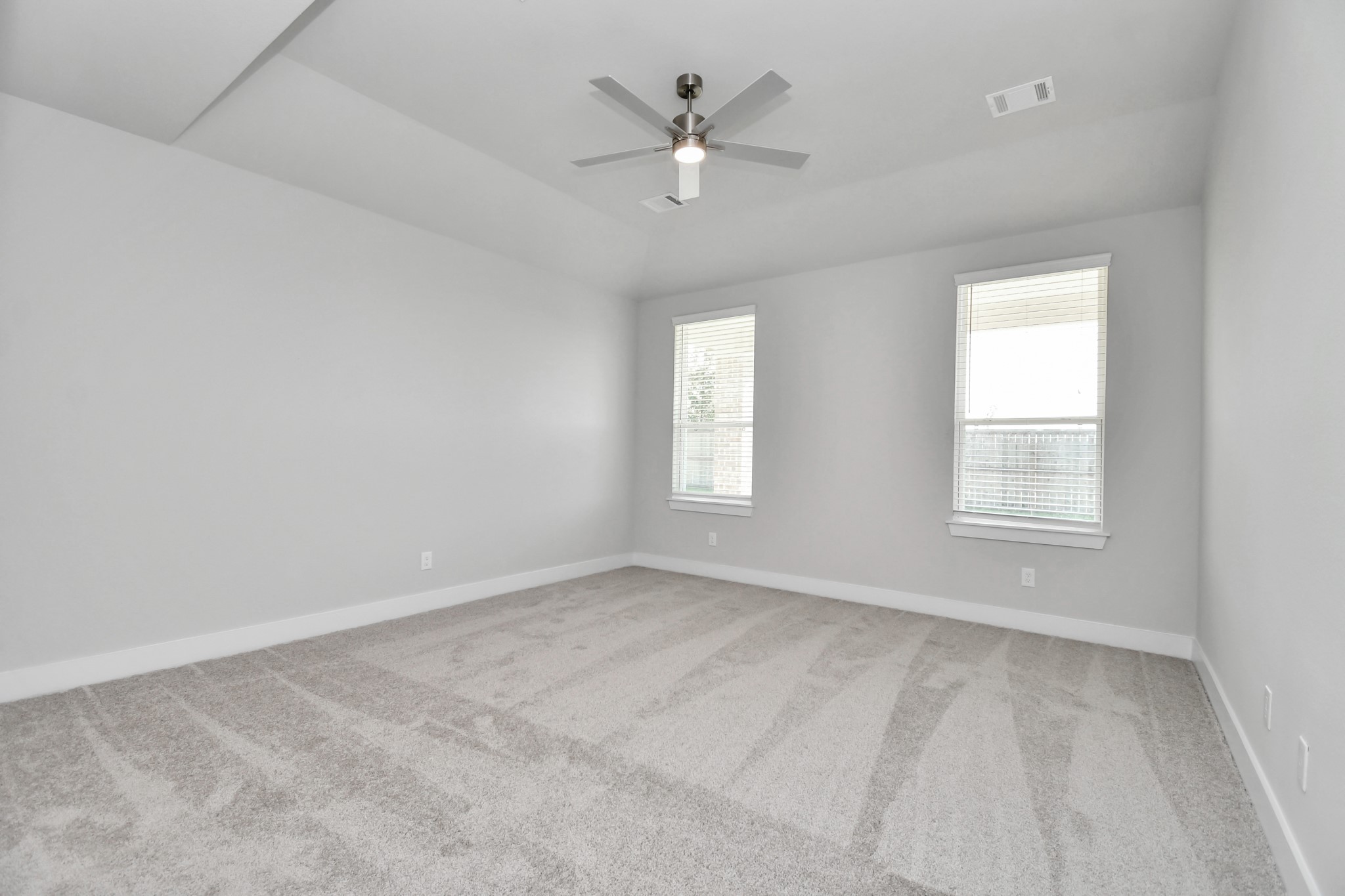 3103 Native Spg Drive Spring, TX 77373 - Photo 19 of 36 an empty room with windows and ceiling fan