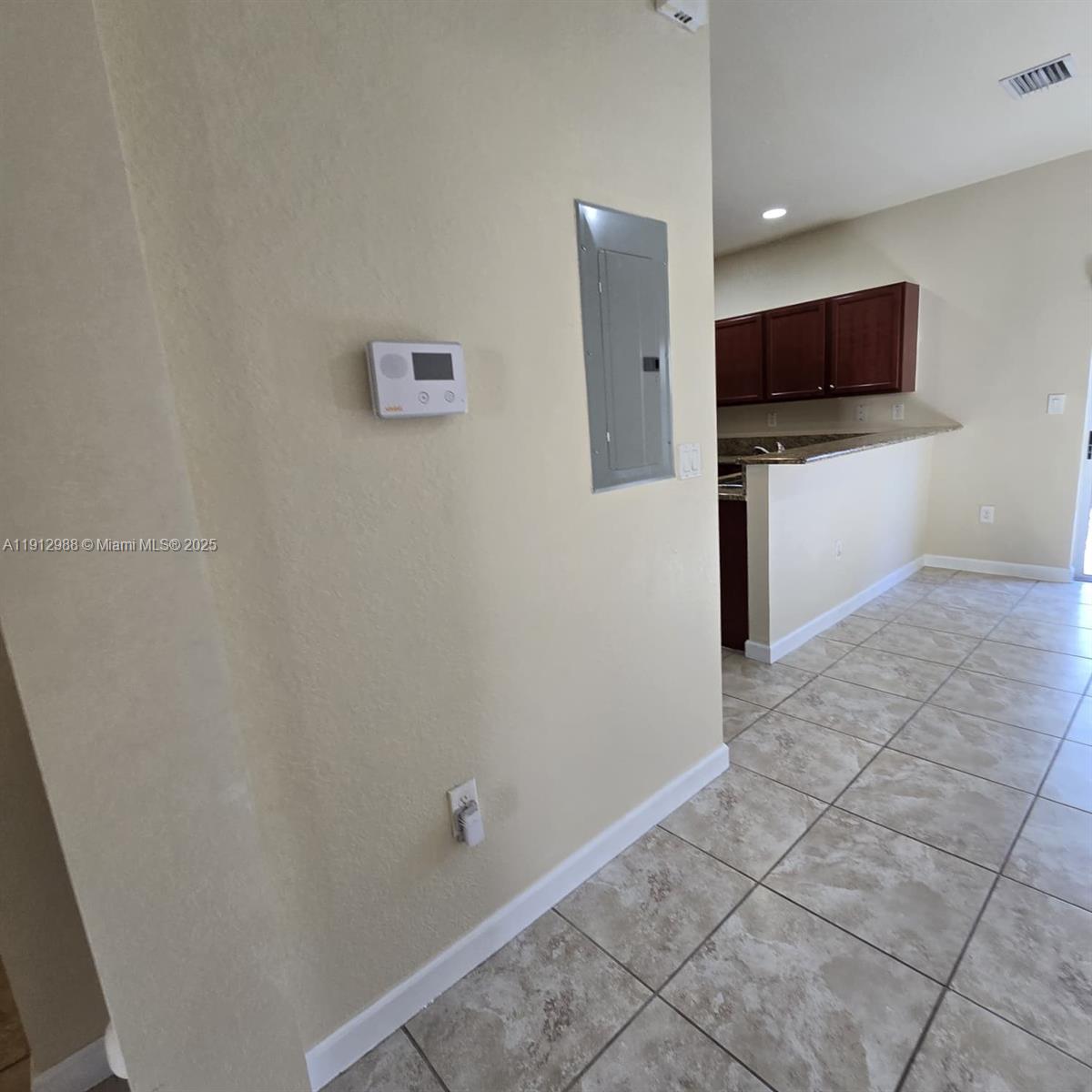 9051 Southwest 227th Street, Unit 3 Cutler Bay, FL 33190 - Photo 11 of 33 a view of a kitchen with an empty space and a window