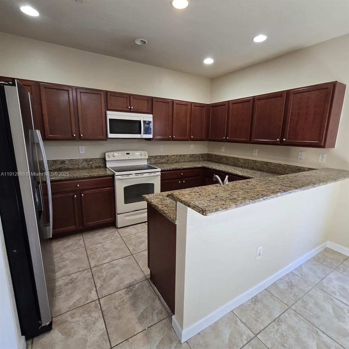 9051 Southwest 227th Street, Unit 3 Cutler Bay, FL 33190 - Photo 12 of 33 a kitchen with a sink a counter top space cabinets and stainless steel appliances