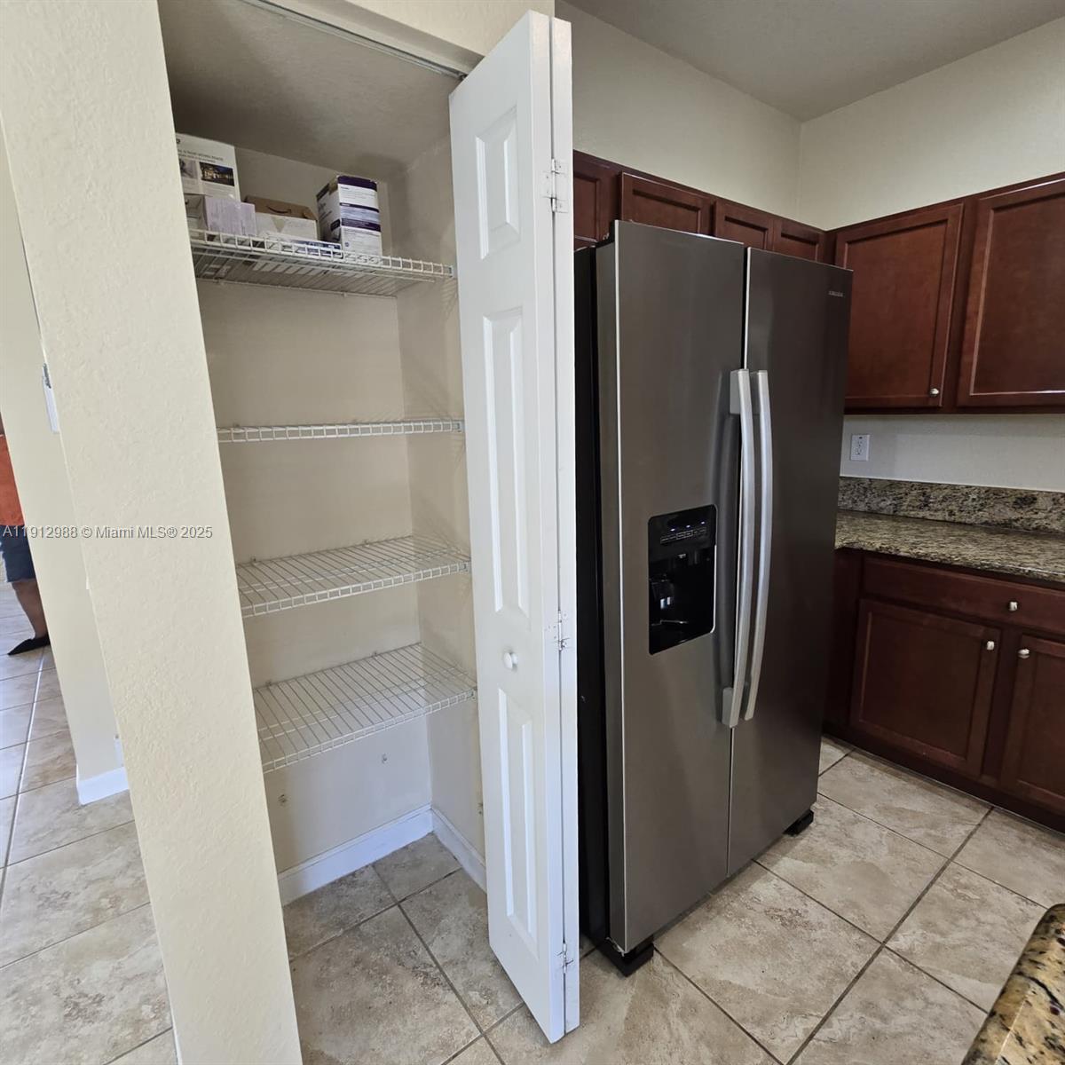 9051 Southwest 227th Street, Unit 3 Cutler Bay, FL 33190 - Photo 13 of 33 a kitchen with a refrigerator and cabinets