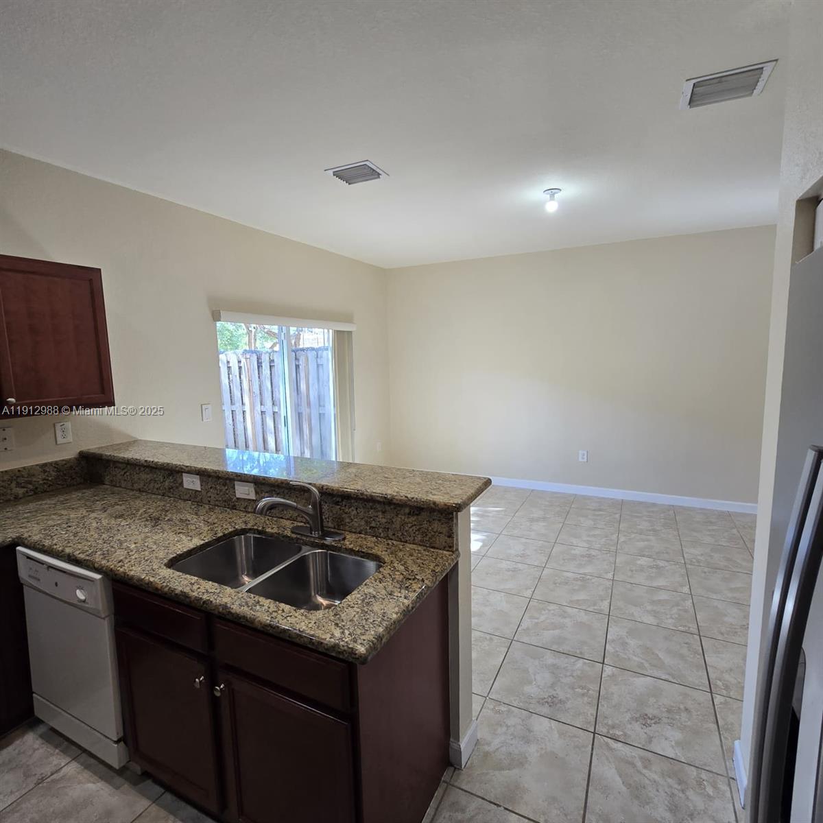 9051 Southwest 227th Street, Unit 3 Cutler Bay, FL 33190 - Photo 15 of 33 a kitchen with granite countertop a sink and a stove