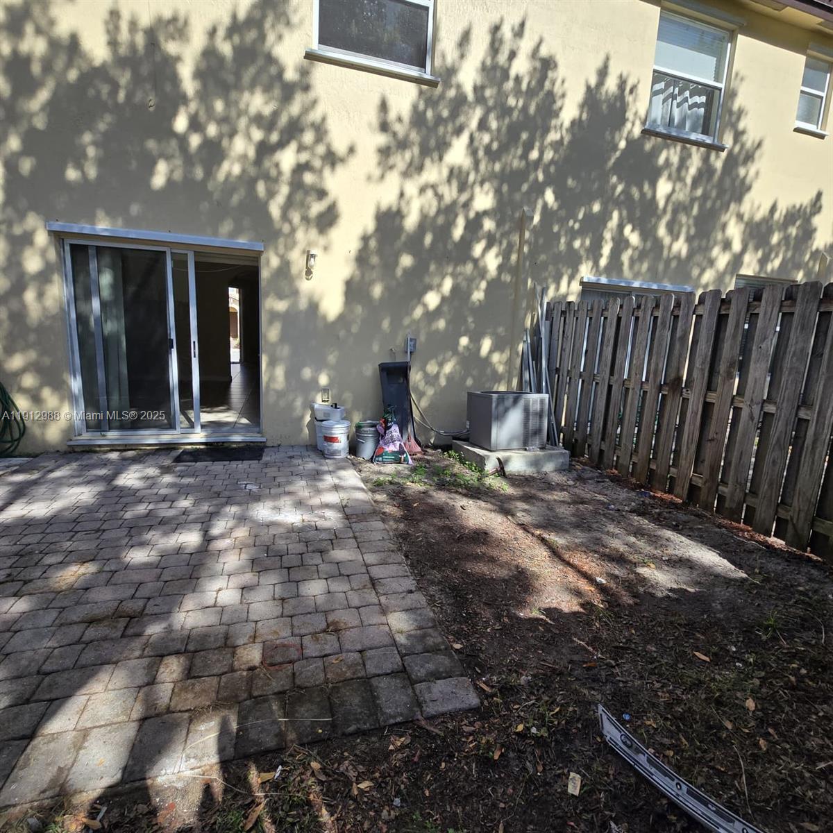 9051 Southwest 227th Street, Unit 3 Cutler Bay, FL 33190 - Photo 17 of 33 a backyard of a house with table and chairs