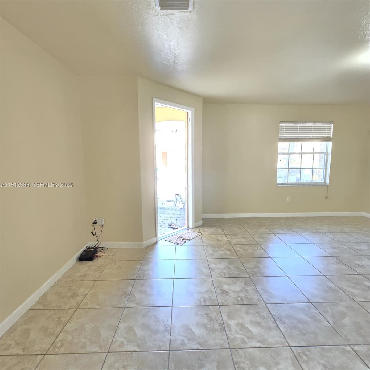 9051 Southwest 227th Street, Unit 3 Cutler Bay, FL 33190 - Photo 2 of 33 a view of an empty room and window