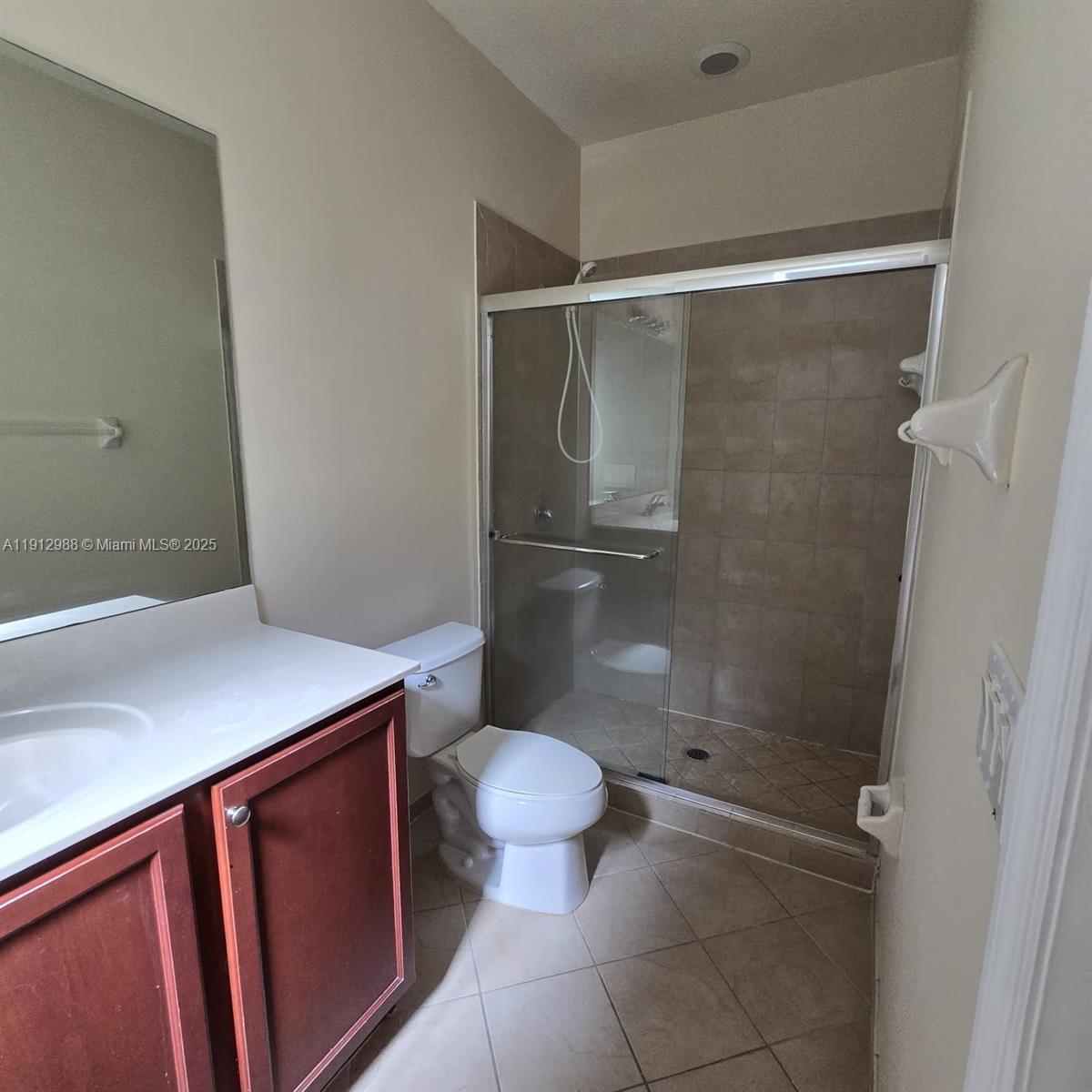 9051 Southwest 227th Street, Unit 3 Cutler Bay, FL 33190 - Photo 22 of 33 a bathroom with a granite countertop sink toilet and a shower