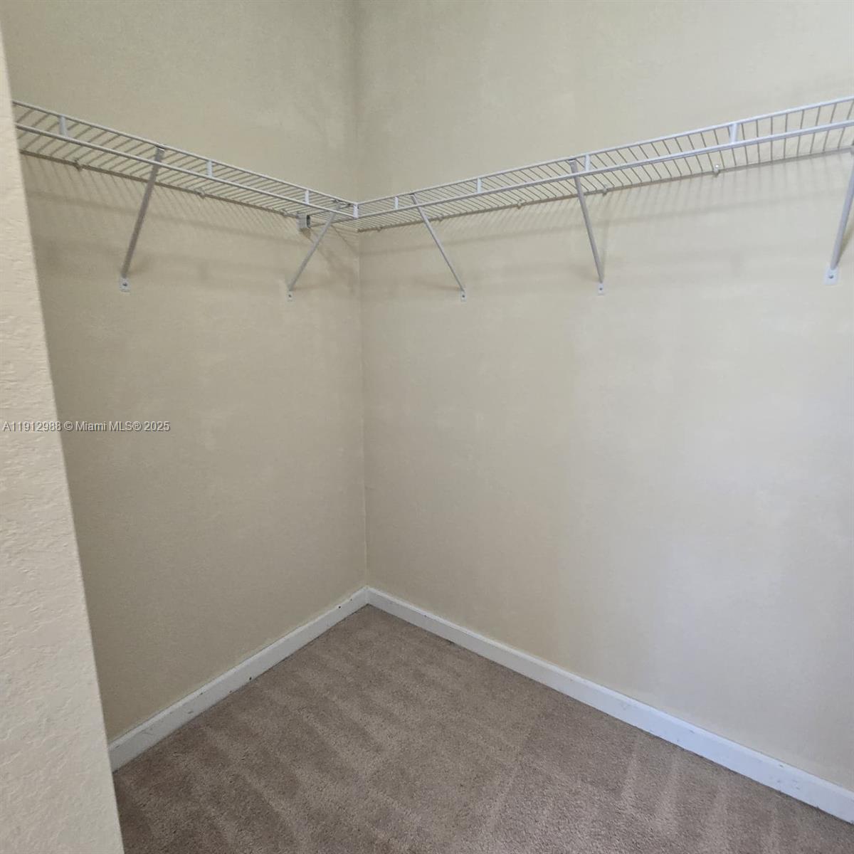 9051 Southwest 227th Street, Unit 3 Cutler Bay, FL 33190 - Photo 26 of 33 a view of a room with racks on the wall