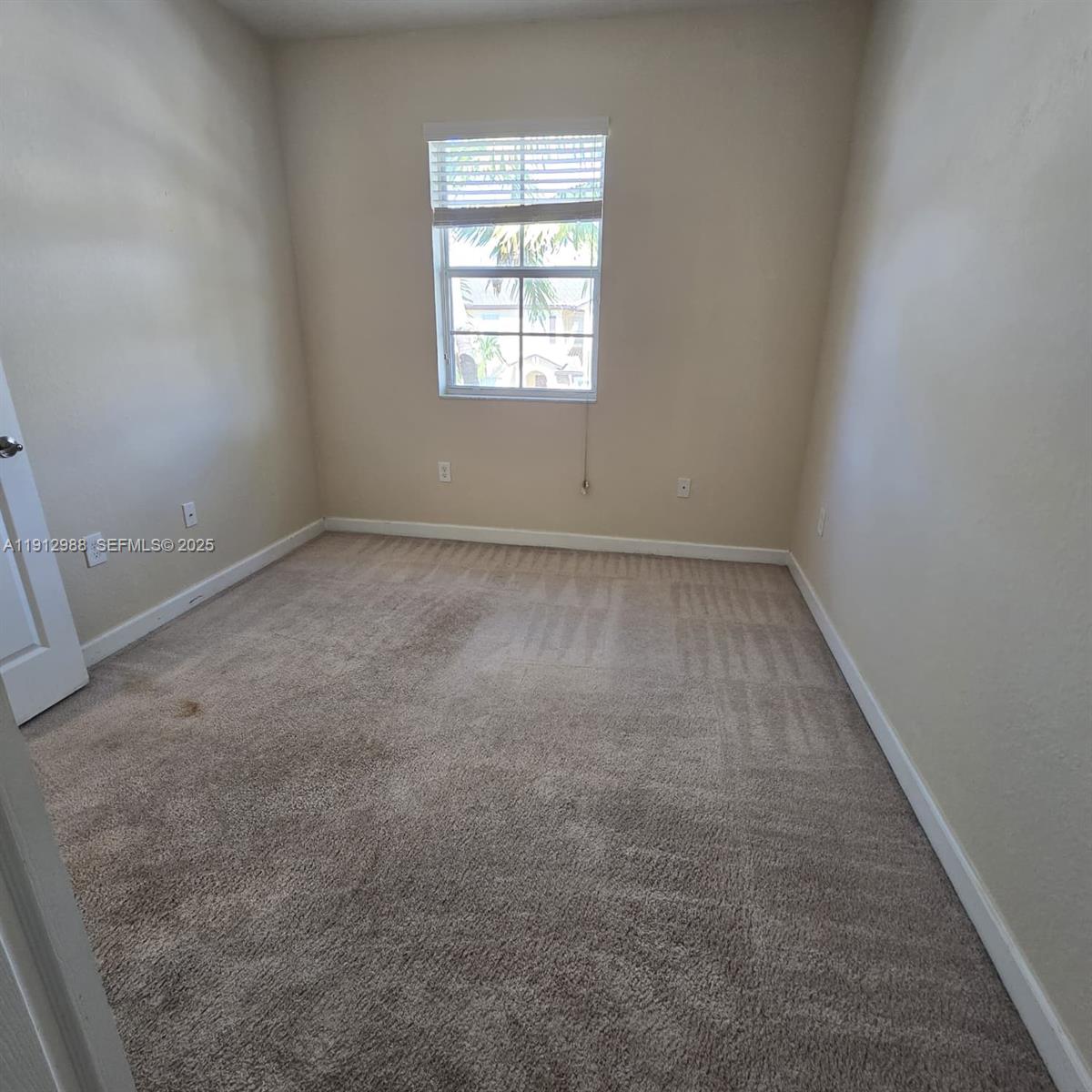 9051 Southwest 227th Street, Unit 3 Cutler Bay, FL 33190 - Photo 29 of 33 an empty room with a window