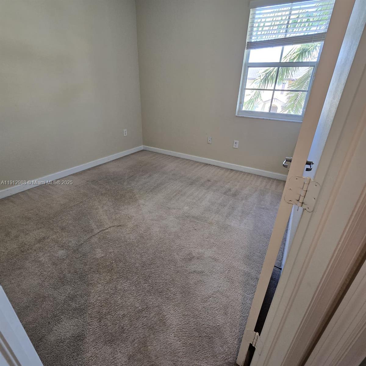9051 Southwest 227th Street, Unit 3 Cutler Bay, FL 33190 - Photo 30 of 33 an empty room with windows