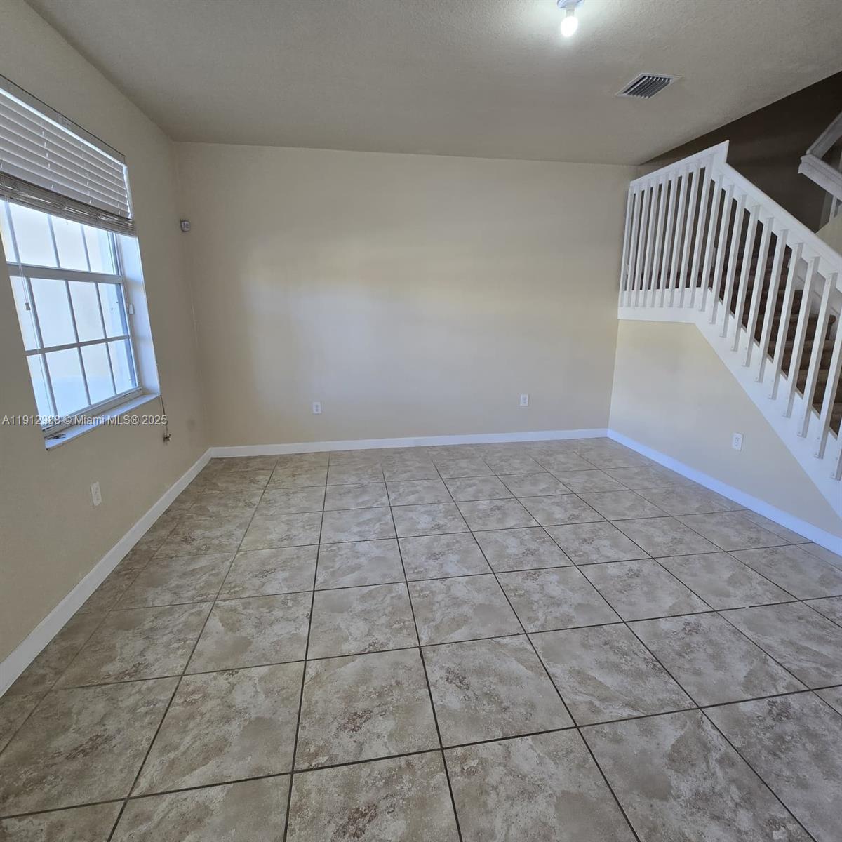 9051 Southwest 227th Street, Unit 3 Cutler Bay, FL 33190 - Photo 3 of 33 a view of an empty room and window