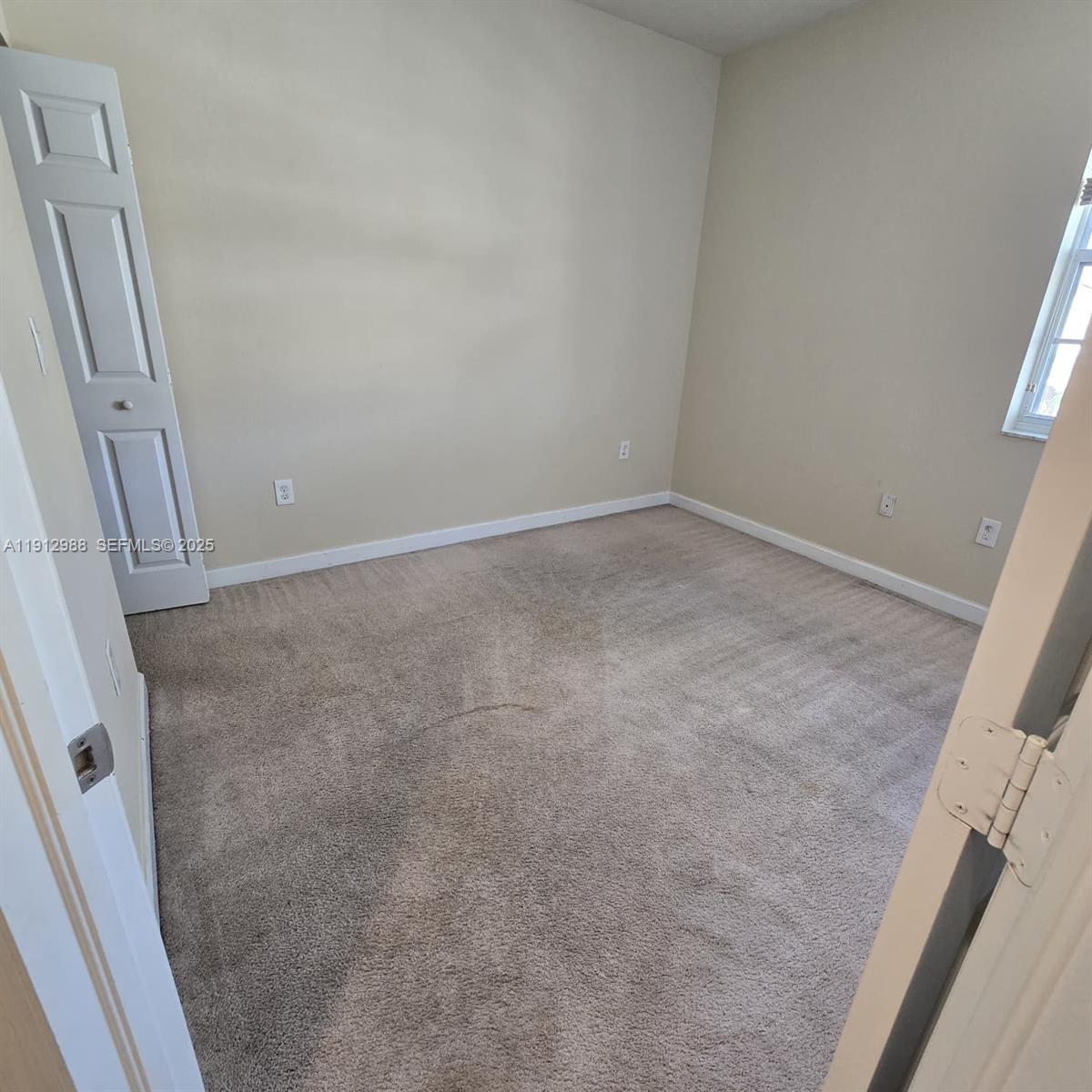 9051 Southwest 227th Street, Unit 3 Cutler Bay, FL 33190 - Photo 33 of 33 an empty room with windows