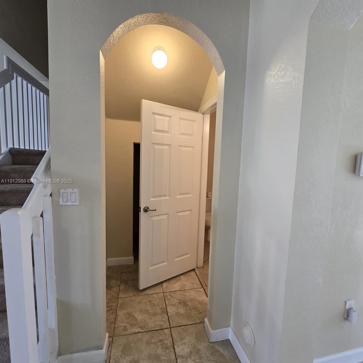 9051 Southwest 227th Street, Unit 3 Cutler Bay, FL 33190 - Photo 6 of 33 a view of a hallway with a door