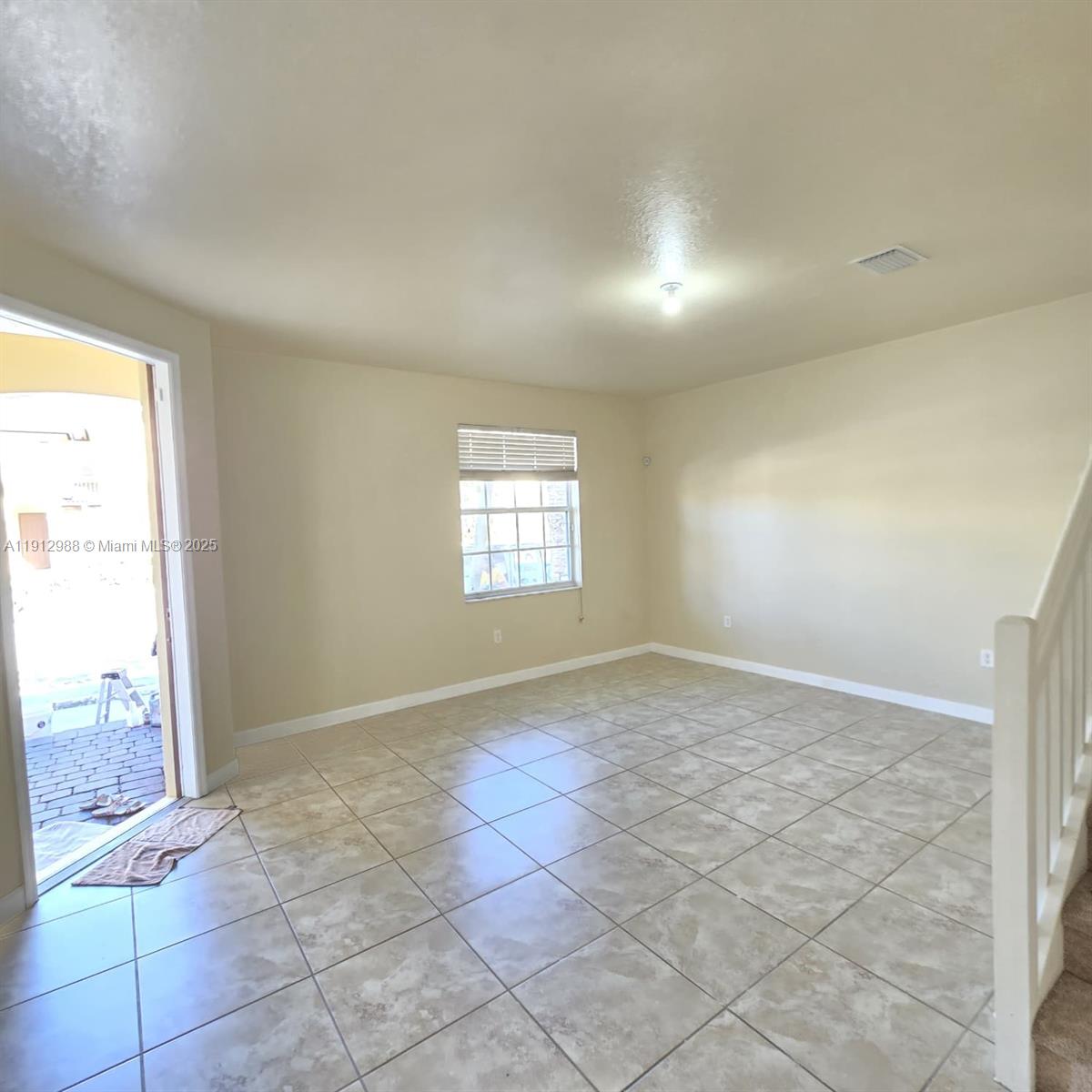 9051 Southwest 227th Street, Unit 3 Cutler Bay, FL 33190 - Photo 9 of 33 an empty room with windows