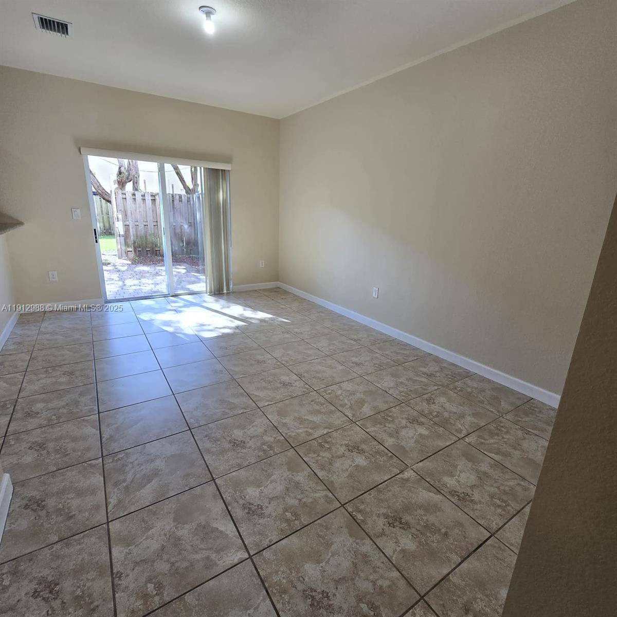 9051 Southwest 227th Street, Unit 3 Cutler Bay, FL 33190 - Photo 10 of 33 an empty room with large windows