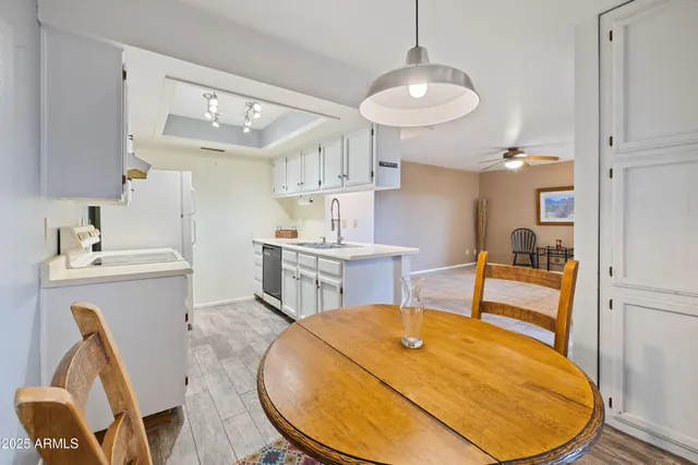 a room with table chairs and wooden floor