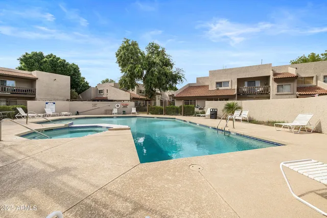a view of a house with swimming pool and a yard