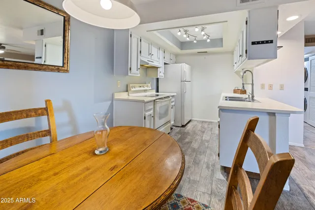 a view of a kitchen with furniture and wooden floor