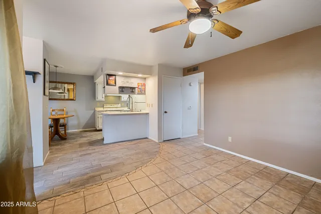 a view of a livingroom with a ceiling fan and a window