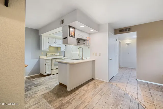a view of a kitchen with sink cabinets and window
