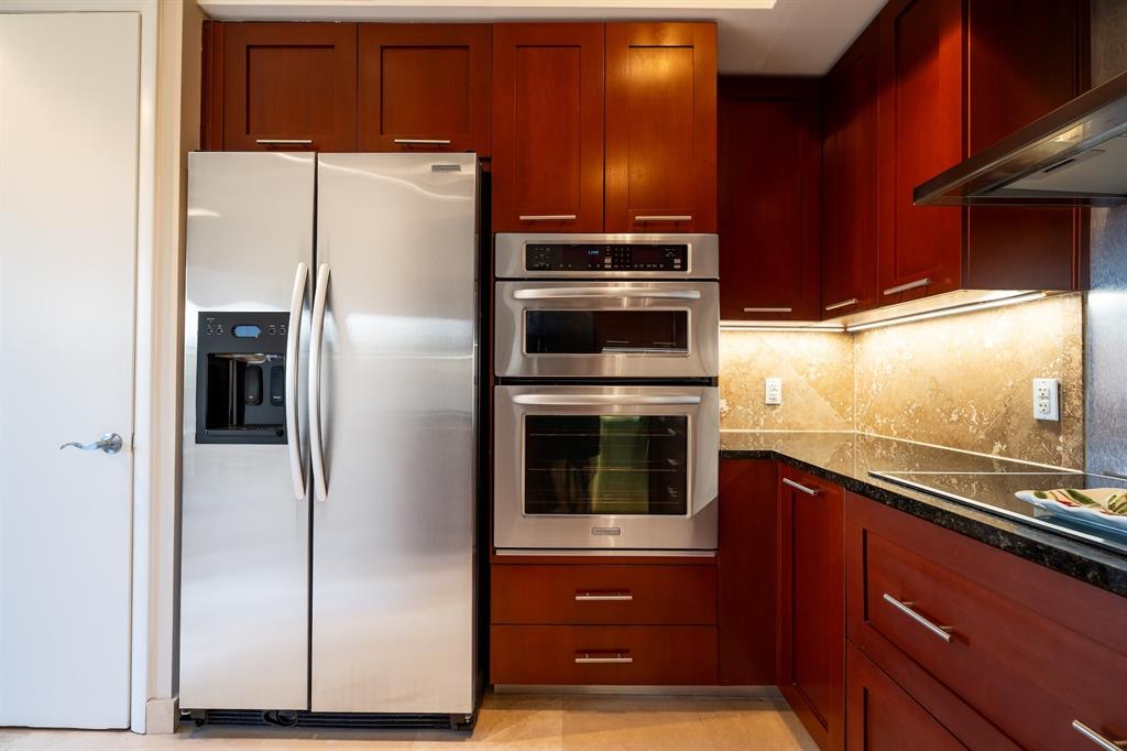 2401 North Ocean Boulevard, Unit 403 Fort Lauderdale, FL 33305 - Photo 11 of 32 a kitchen with stainless steel appliances a refrigerator and a stove top oven