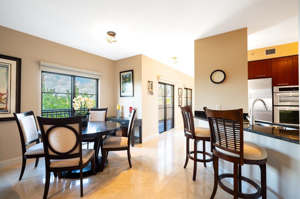 2401 North Ocean Boulevard, Unit 403 Fort Lauderdale, FL 33305 - Photo 12 of 32 a dining room with furniture a window and wooden floor