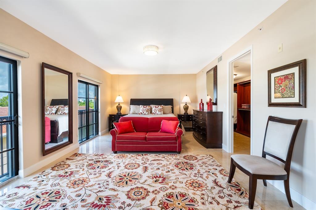 2401 North Ocean Boulevard, Unit 403 Fort Lauderdale, FL 33305 - Photo 13 of 32 a bedroom with a bed and wooden floor