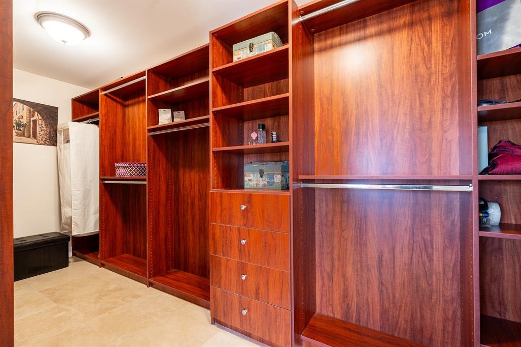 2401 North Ocean Boulevard, Unit 403 Fort Lauderdale, FL 33305 - Photo 15 of 32 a view of walk in closet with clothes and shoes