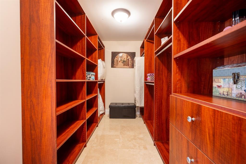 2401 North Ocean Boulevard, Unit 403 Fort Lauderdale, FL 33305 - Photo 17 of 32 a view of walk in closet with clothes and shoes